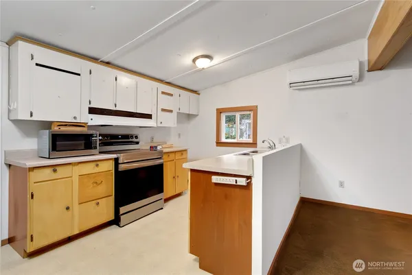 a kitchen with stainless steel appliances and white cabinets