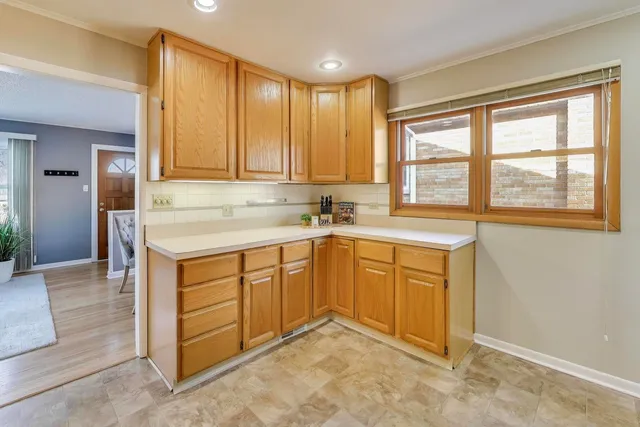 a kitchen with granite countertop a sink and cabinets