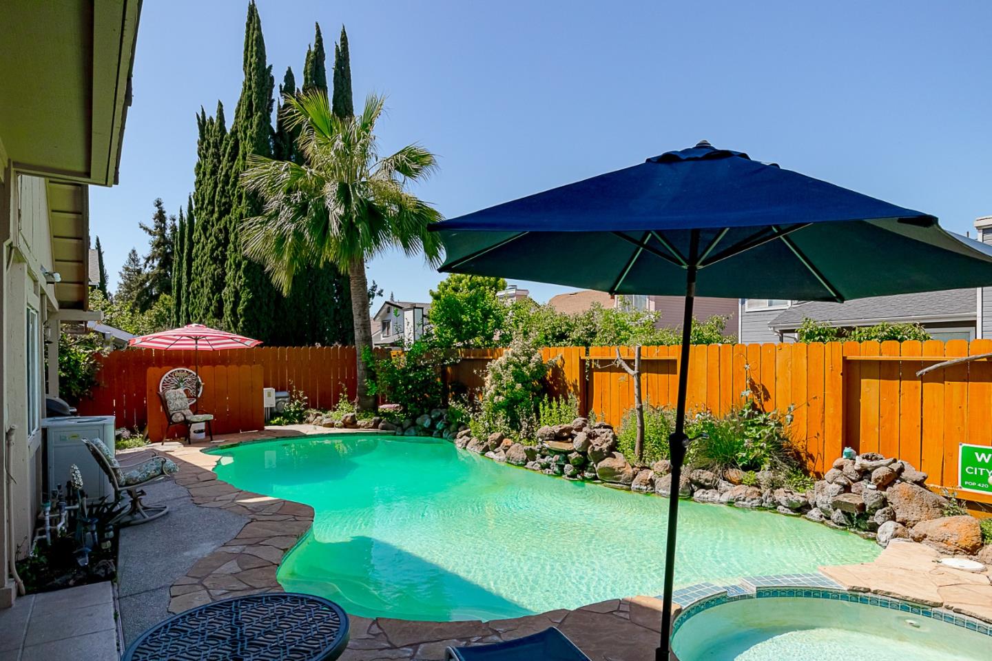 2413 Boston Way Modesto, CA 95355 - Photo 23 of 24 a view of a yard with an umbrella and table under an umbrella