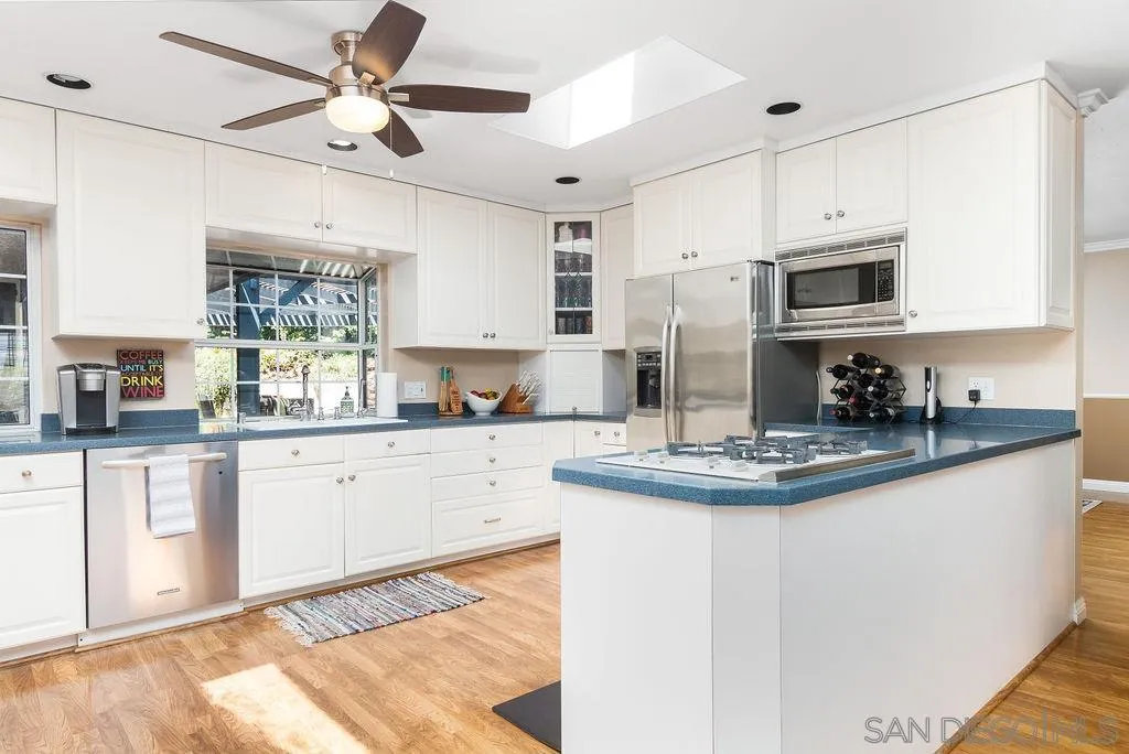 10750 Anaheim Drive La Mesa, CA 91941 - Photo 11 of 34 a kitchen with stainless steel appliances granite countertop a stove a sink and a microwave