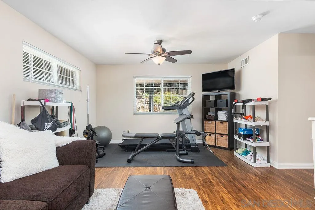 10750 Anaheim Drive La Mesa, CA 91941 - Photo 17 of 34 a living room with furniture a flat screen tv and a book shelf
