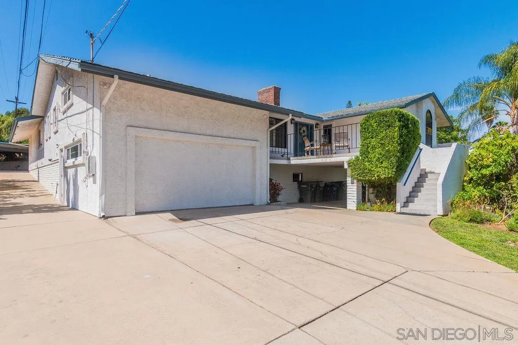 10750 Anaheim Drive La Mesa, CA 91941 - Photo 34 of 34 a front view of a house with a yard and garage