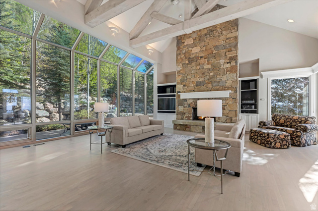 3222 Eagle View Circle Sandy, UT 84092 - Photo 12 of 60 Living room with a sunroom, built in features, a fireplace, and wood finished floors
