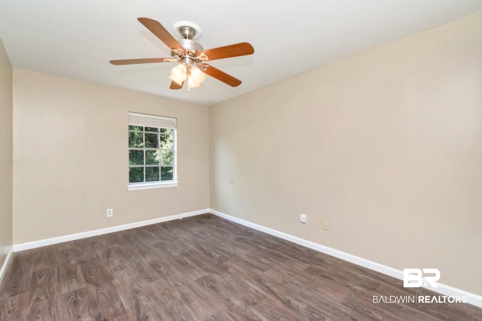 110 Du Rhu Drive, Unit E Mobile, AL 36608 - Photo 15 of 19 Empty room with dark wood finished floors and a ceiling fan