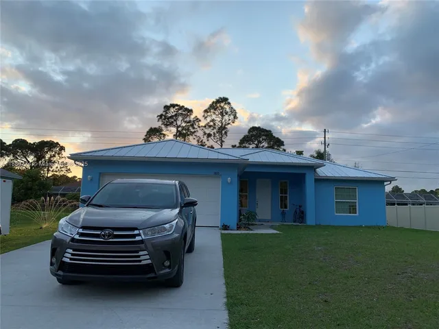 a front view of a house with a garden