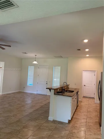 a view of kitchen with refrigerator sink and a stove