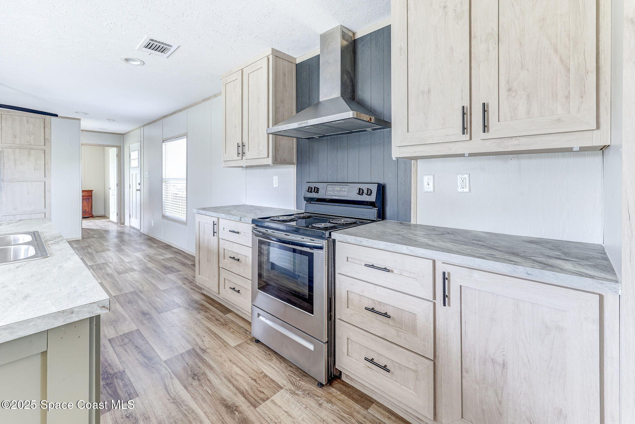 800 Phyllis Way Cocoa, FL 32926 - Photo 11 of 40 a kitchen with granite countertop white cabinets and stainless steel appliances