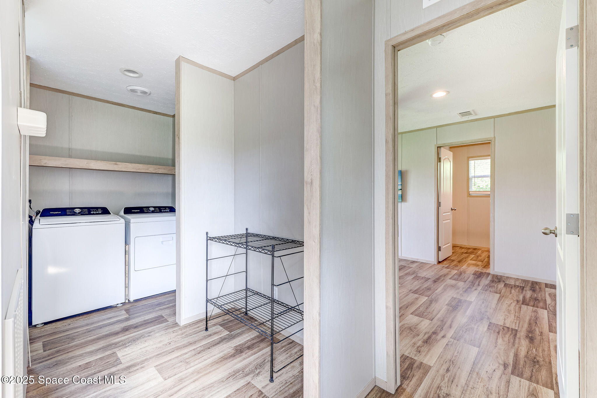 800 Phyllis Way Cocoa, FL 32926 - Photo 16 of 40 a view of a room with wooden floor and cabinet