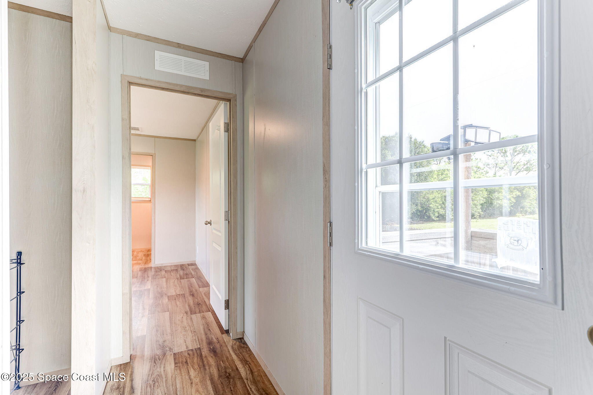 800 Phyllis Way Cocoa, FL 32926 - Photo 17 of 40 a view of a room with wooden floor closet and windows