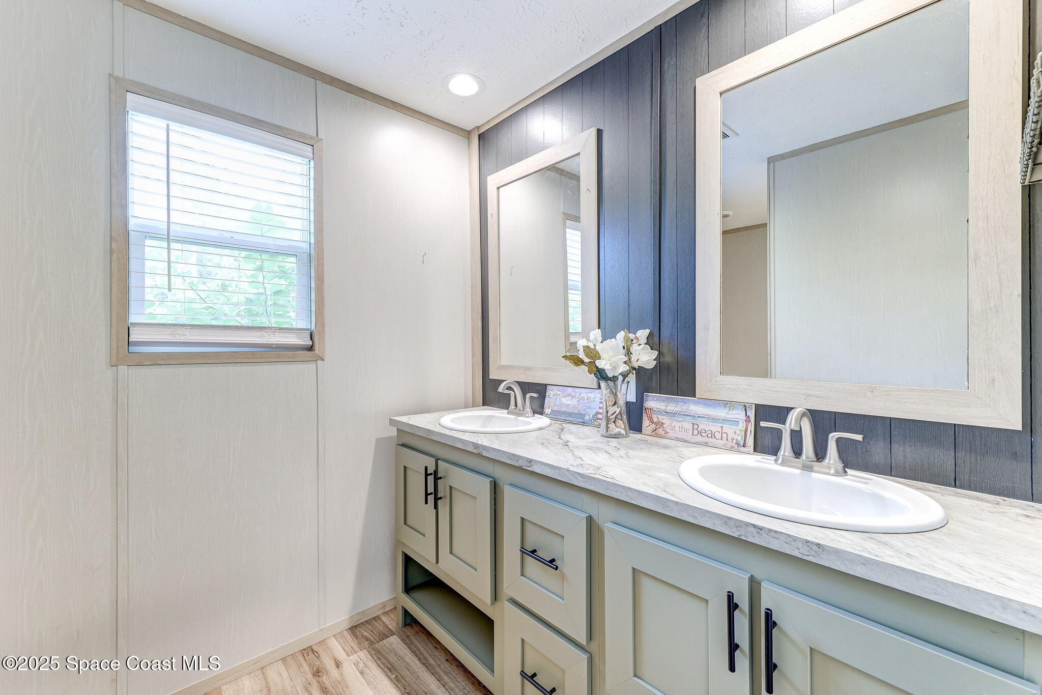 800 Phyllis Way Cocoa, FL 32926 - Photo 21 of 40 a bathroom with a granite countertop sink and a mirror