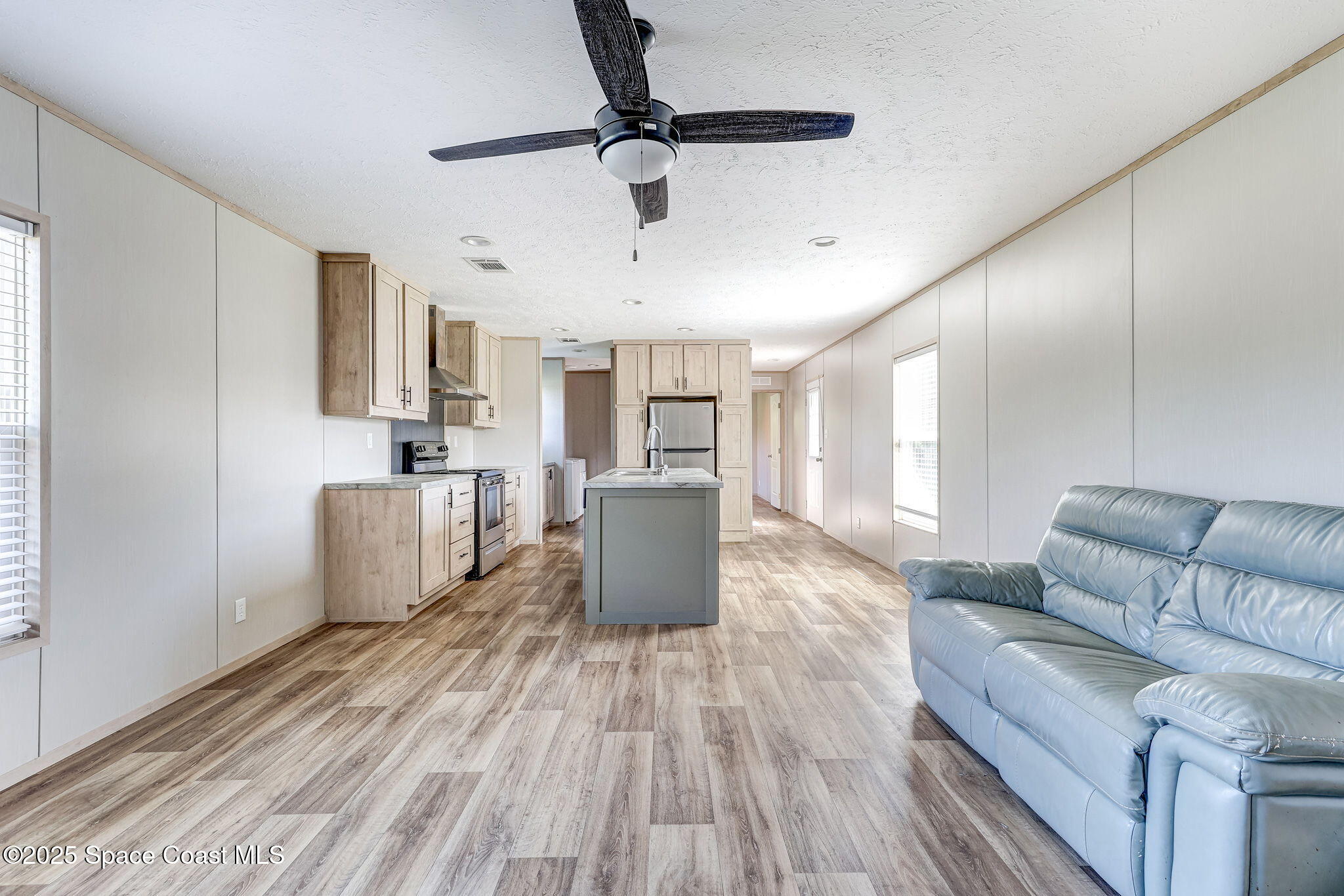 800 Phyllis Way Cocoa, FL 32926 - Photo 3 of 40 a living room with furniture and a wooden floor