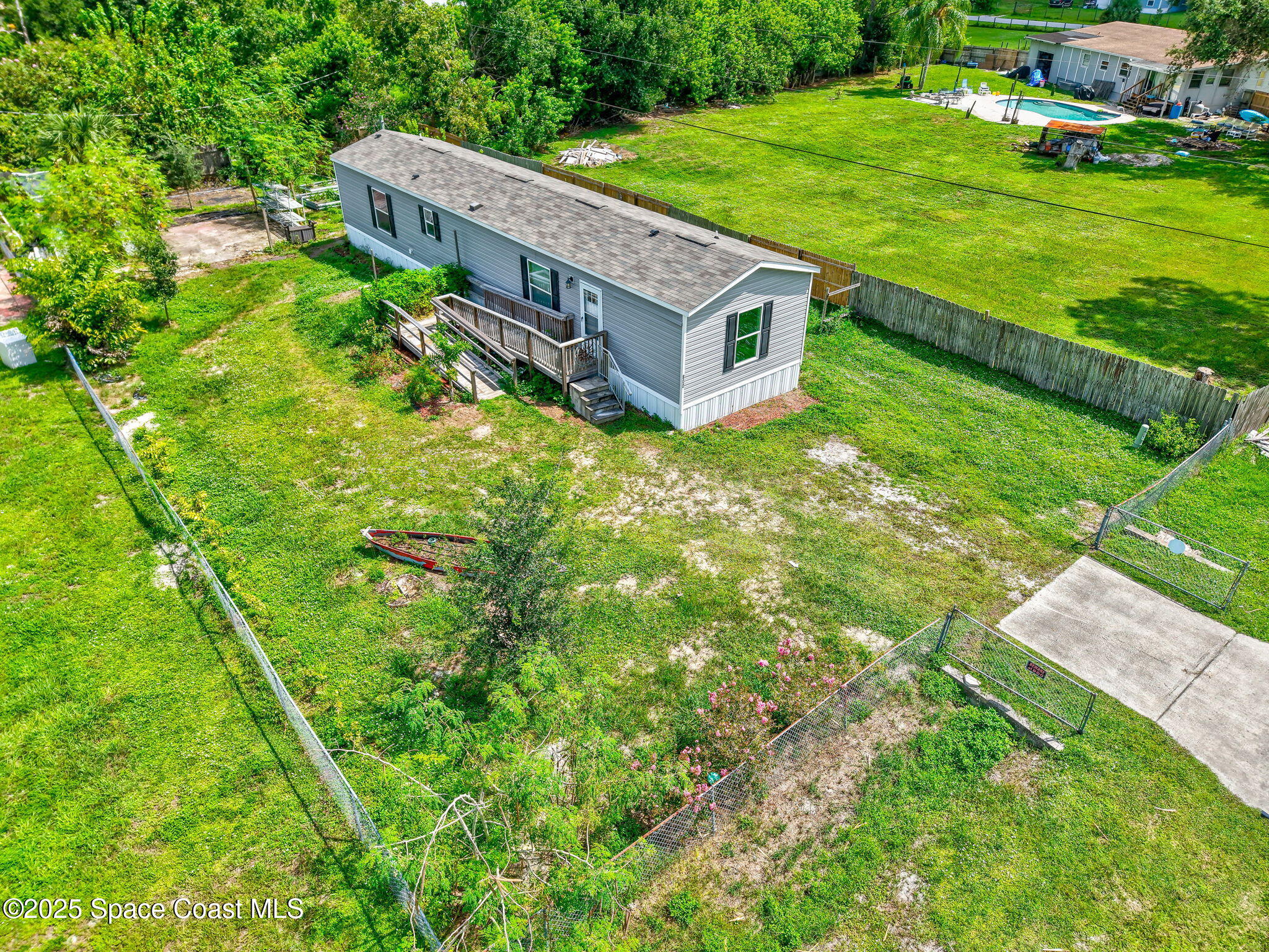 800 Phyllis Way Cocoa, FL 32926 - Photo 35 of 40 a view of a house with a big yard and large trees