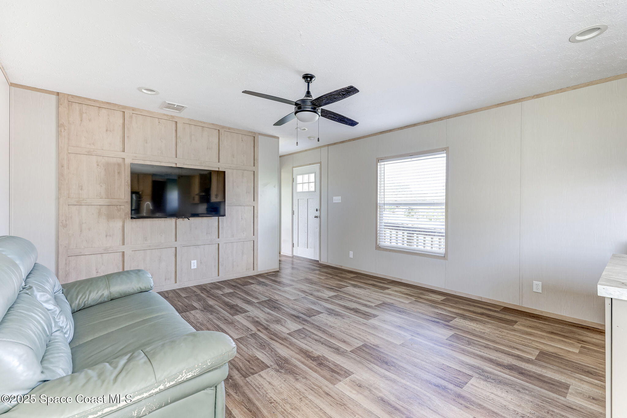 800 Phyllis Way Cocoa, FL 32926 - Photo 6 of 40 a living room with furniture and a flat screen tv