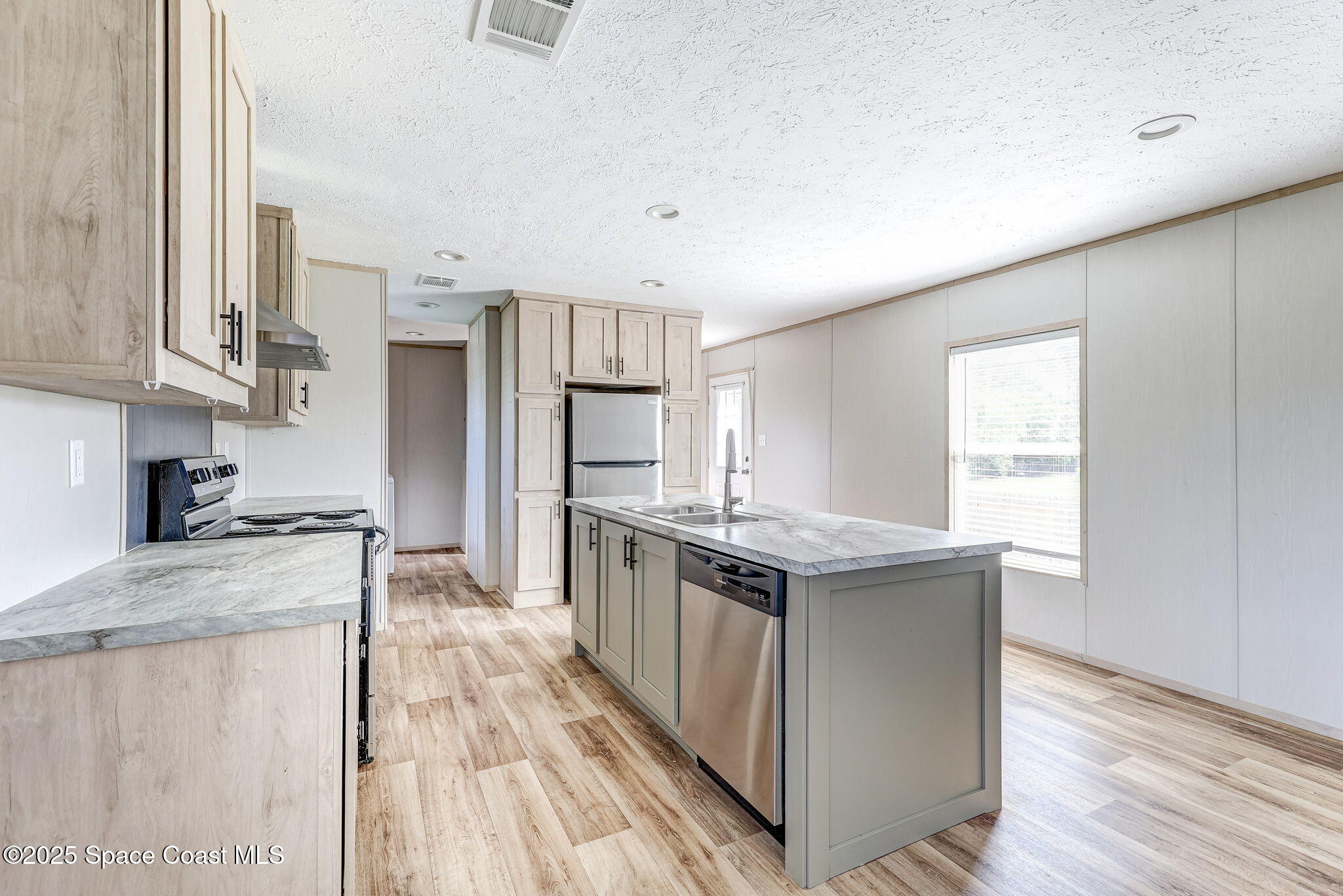 800 Phyllis Way Cocoa, FL 32926 - Photo 8 of 40 a kitchen with stainless steel appliances granite countertop a refrigerator a sink dishwasher a stove and white countertops with wooden floor