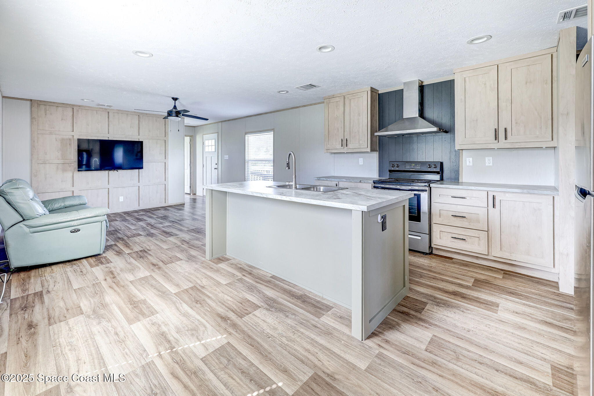 800 Phyllis Way Cocoa, FL 32926 - Photo 10 of 40 a kitchen with stainless steel appliances a sink cabinets and wooden floor
