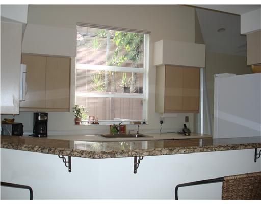 a kitchen with granite countertop a sink and a counter top space