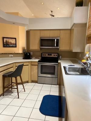 a kitchen with a stove a sink and a microwave