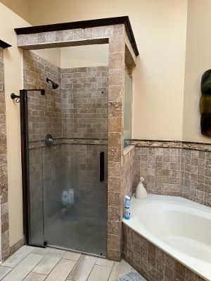 a bathroom with a shower and a bathtub