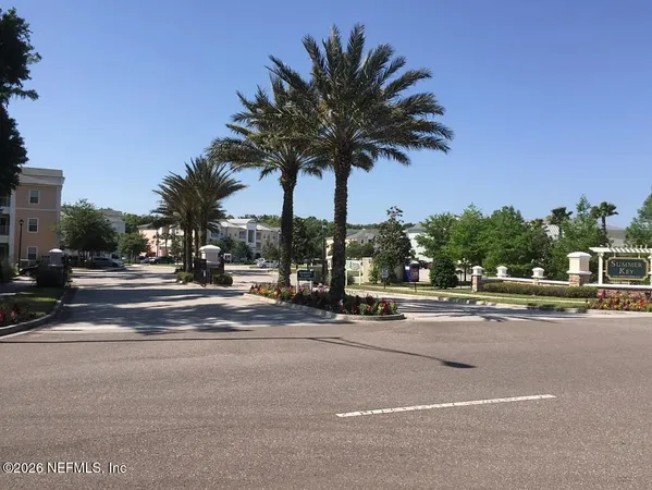 a view of street with palm trees