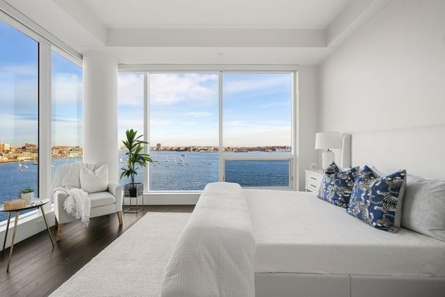 a bedroom with a large bed and a night stand