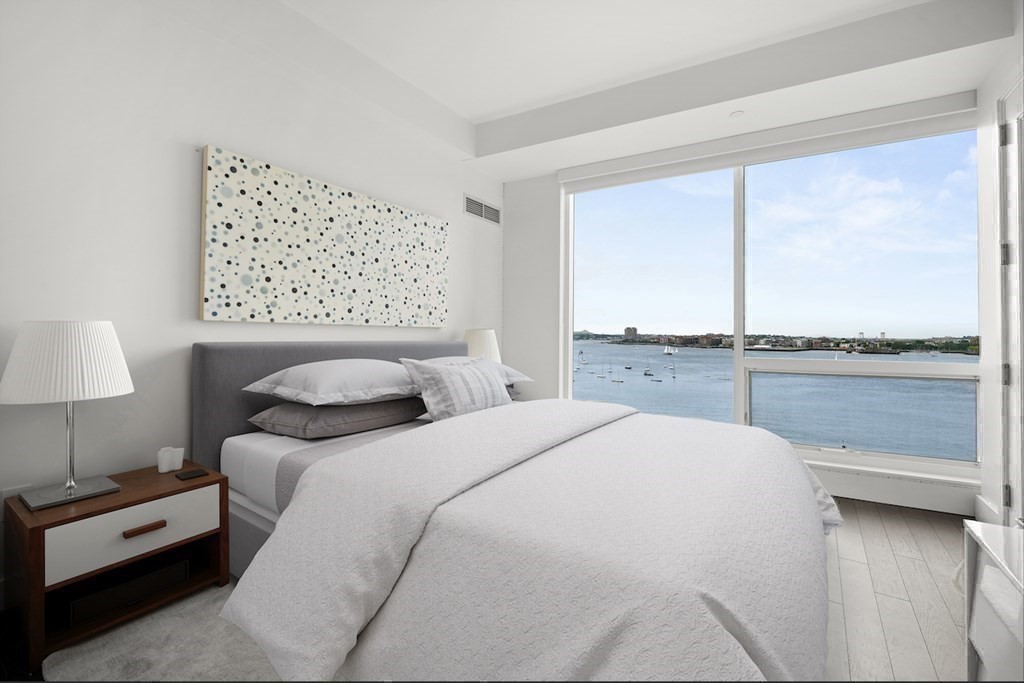 22 Liberty Drive, Unit 7A Boston, MA 02210 - Photo 18 of 31 a bedroom with a large bed and a night stand