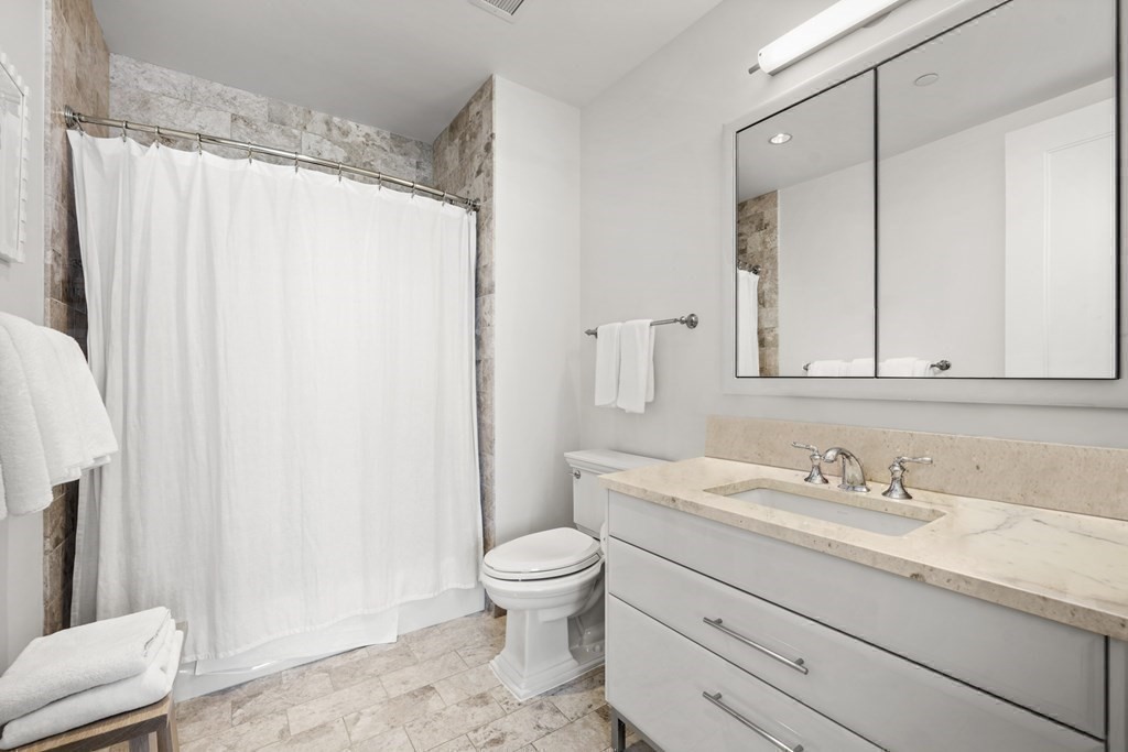 22 Liberty Drive, Unit 7A Boston, MA 02210 - Photo 19 of 31 a bathroom with a granite countertop sink toilet and shower
