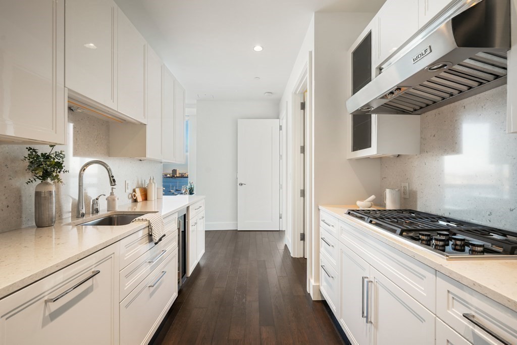 22 Liberty Drive, Unit 7A Boston, MA 02210 - Photo 22 of 31 a kitchen with stainless steel appliances a sink a stove and cabinets