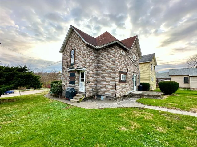 a view of a house with a yard porch and sitting area