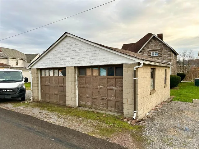 a view of a house with a yard and garage