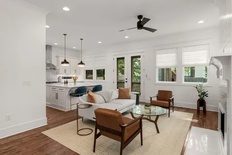 a living room with furniture and a wooden floor