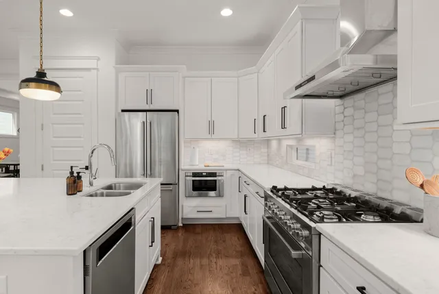 a kitchen with a sink stainless steel appliances and cabinets