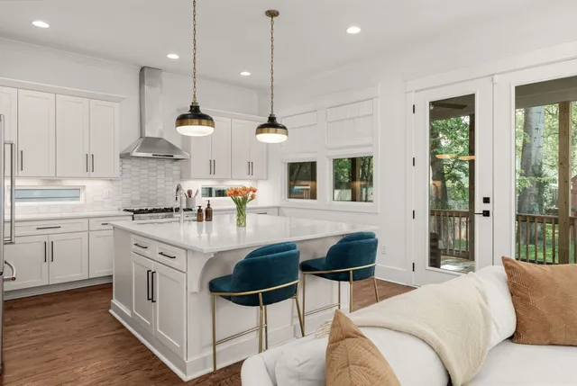 a kitchen with stainless steel appliances granite countertop a stove a sink and a refrigerator