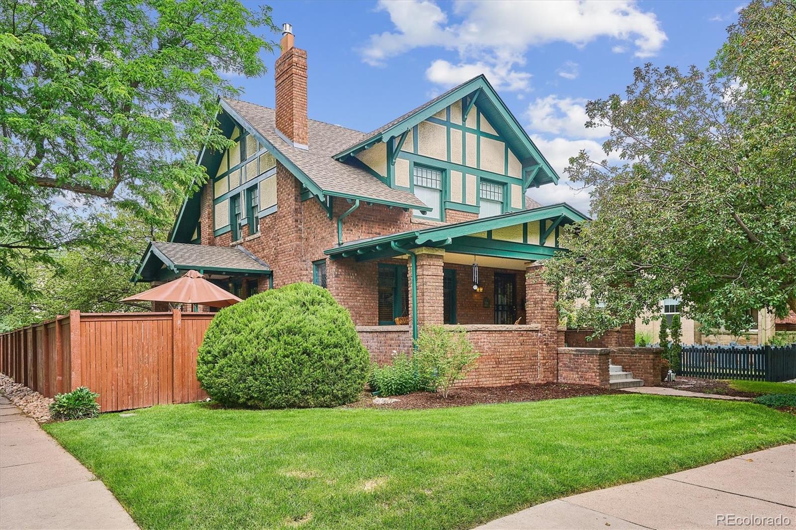 2201 Cherry Street Denver, CO 80207 - Photo 1 of 46 a front view of a house with a yard