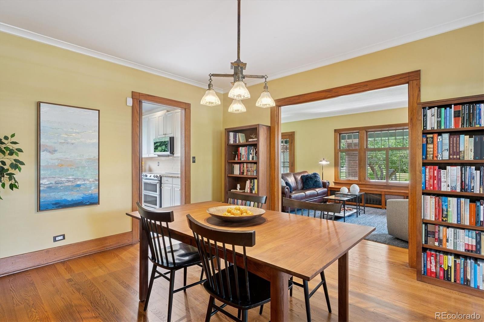 2201 Cherry Street Denver, CO 80207 - Photo 13 of 46 a view of a dining room with furniture and a book shelf