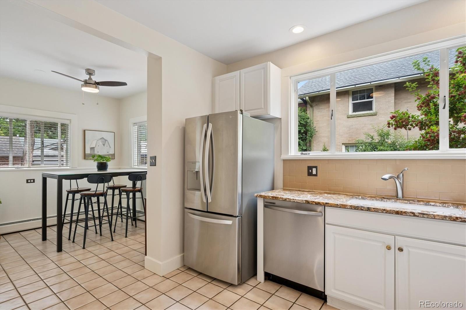 2201 Cherry Street Denver, CO 80207 - Photo 17 of 46 a kitchen with a refrigerator a sink and dishwasher