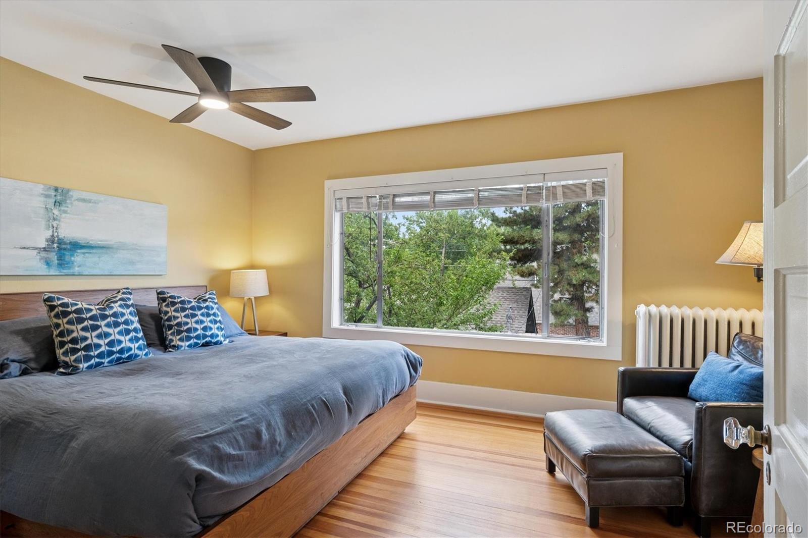 2201 Cherry Street Denver, CO 80207 - Photo 20 of 46 a bedroom with a bed and a large window