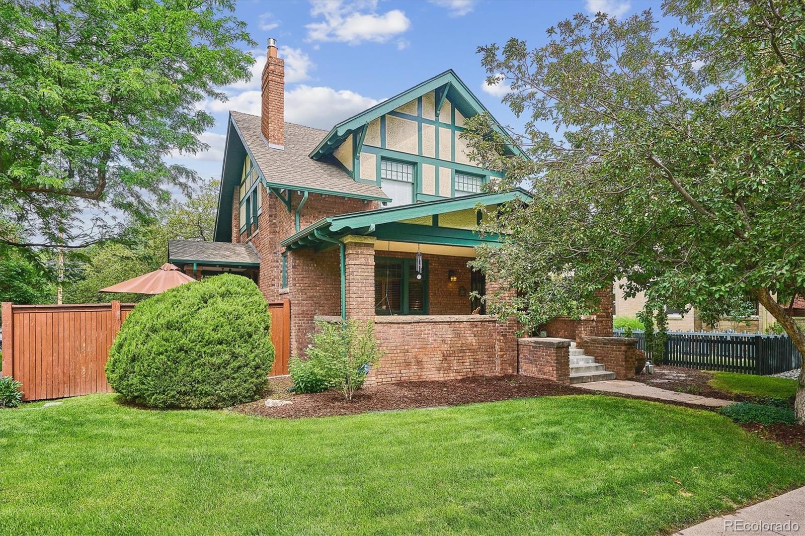 2201 Cherry Street Denver, CO 80207 - Photo 2 of 46 a front view of a house with a yard