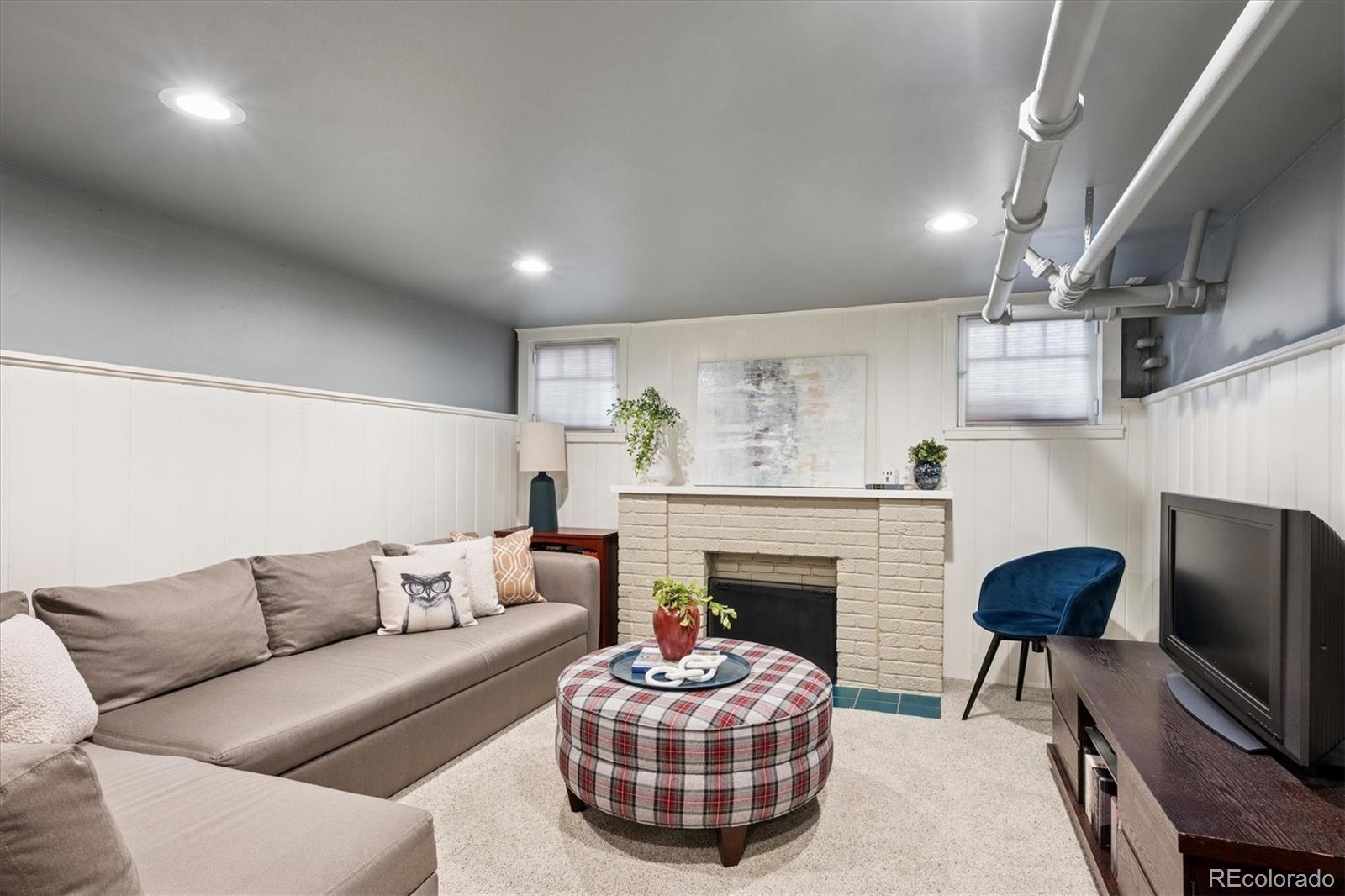 2201 Cherry Street Denver, CO 80207 - Photo 30 of 46 a living room with furniture and a fireplace