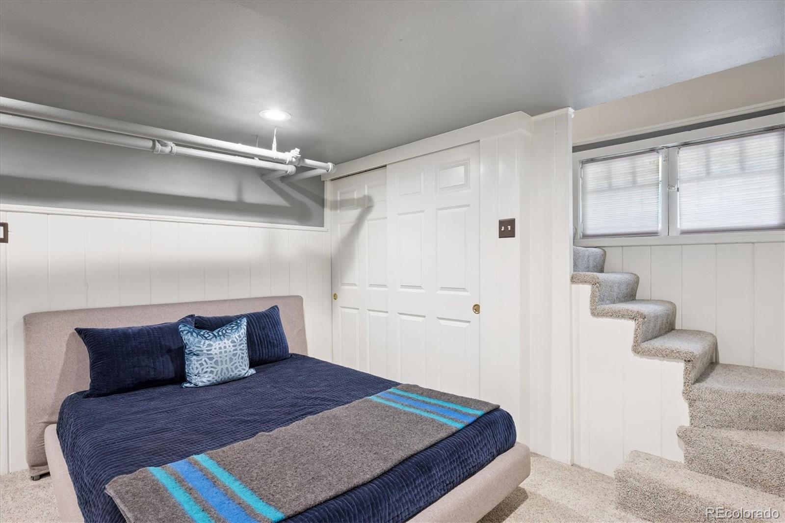 2201 Cherry Street Denver, CO 80207 - Photo 32 of 46 a bedroom with a bed and window