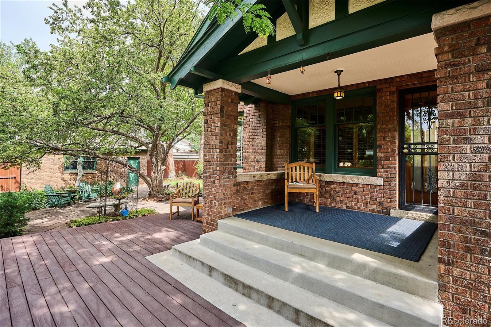 2201 Cherry Street Denver, CO 80207 - Photo 37 of 46 a view of a patio with table and chairs and wooden floor