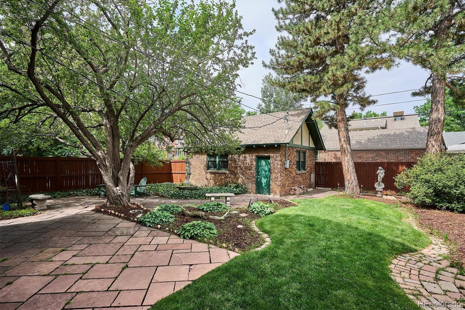 2201 Cherry Street Denver, CO 80207 - Photo 43 of 46 a front view of a house with a yard and trees