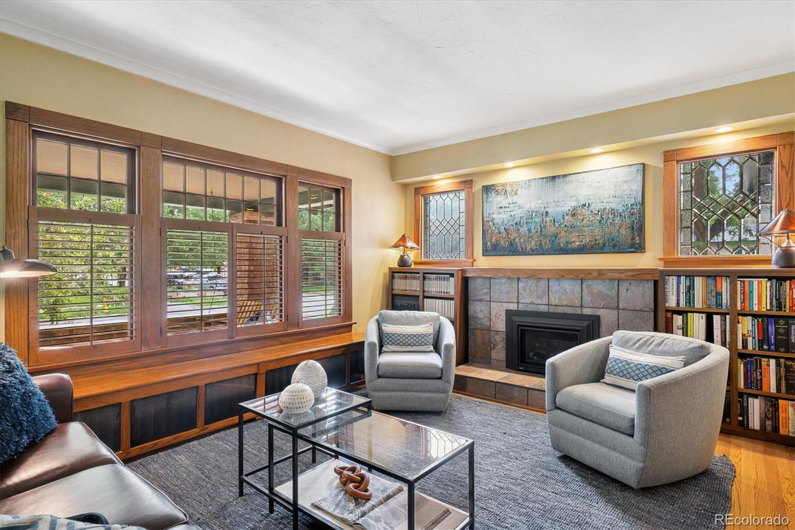 2201 Cherry Street Denver, CO 80207 - Photo 5 of 46 a living room with furniture a fireplace and a floor to ceiling window