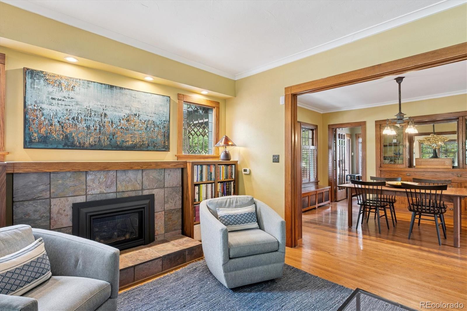 2201 Cherry Street Denver, CO 80207 - Photo 7 of 46 a living room with furniture a large window and a fireplace