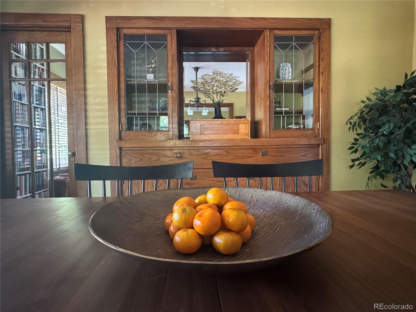 2201 Cherry Street Denver, CO 80207 - Photo 8 of 46 a view of a dining room with furniture wooden floor and a floor to ceiling window