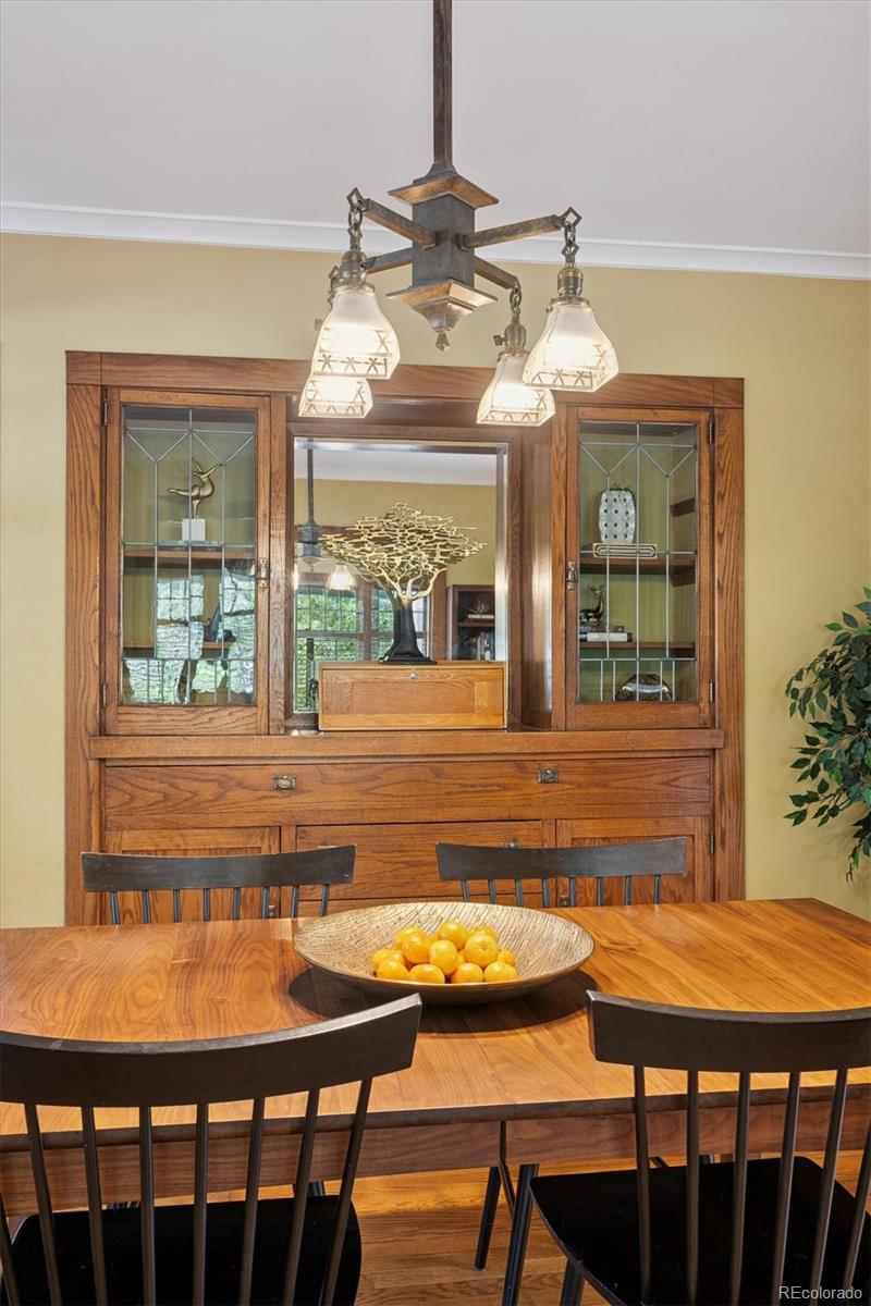 2201 Cherry Street Denver, CO 80207 - Photo 9 of 46 a view of a dining room with furniture a chandelier and wooden floor