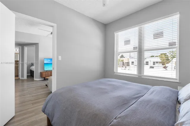 a living room with a bed and a window