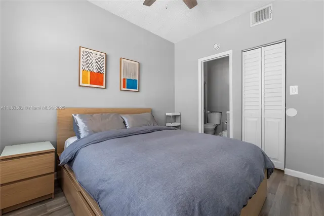 a bedroom with a bed and a night stand