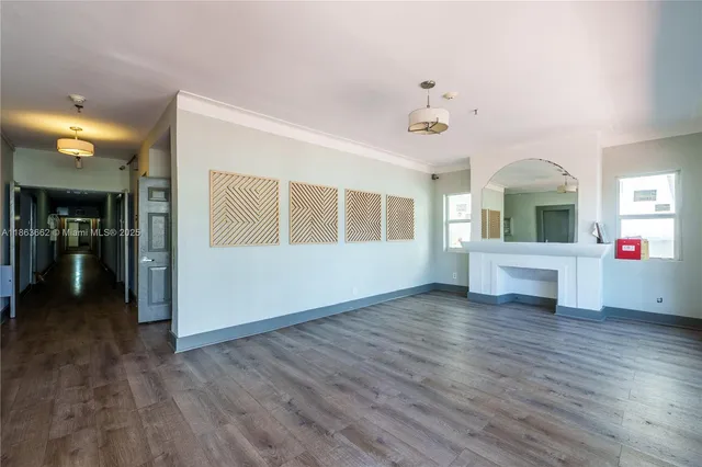 a living room with fireplace furniture and a wooden floor