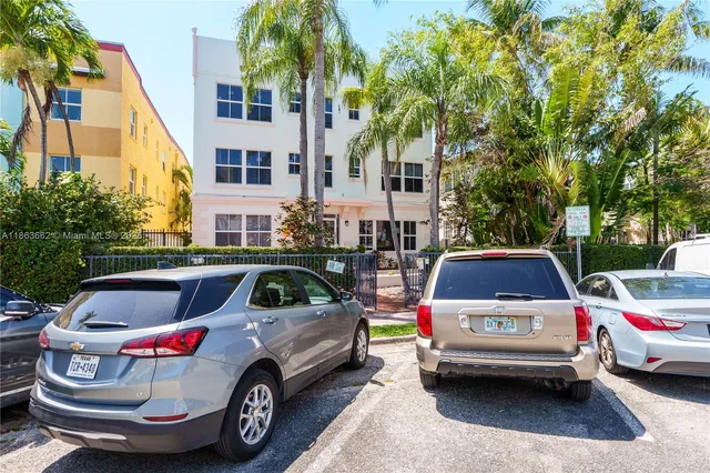 a car parked in front of a white house