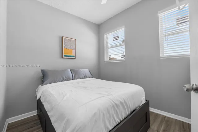 a large bed in a bedroom next to a window
